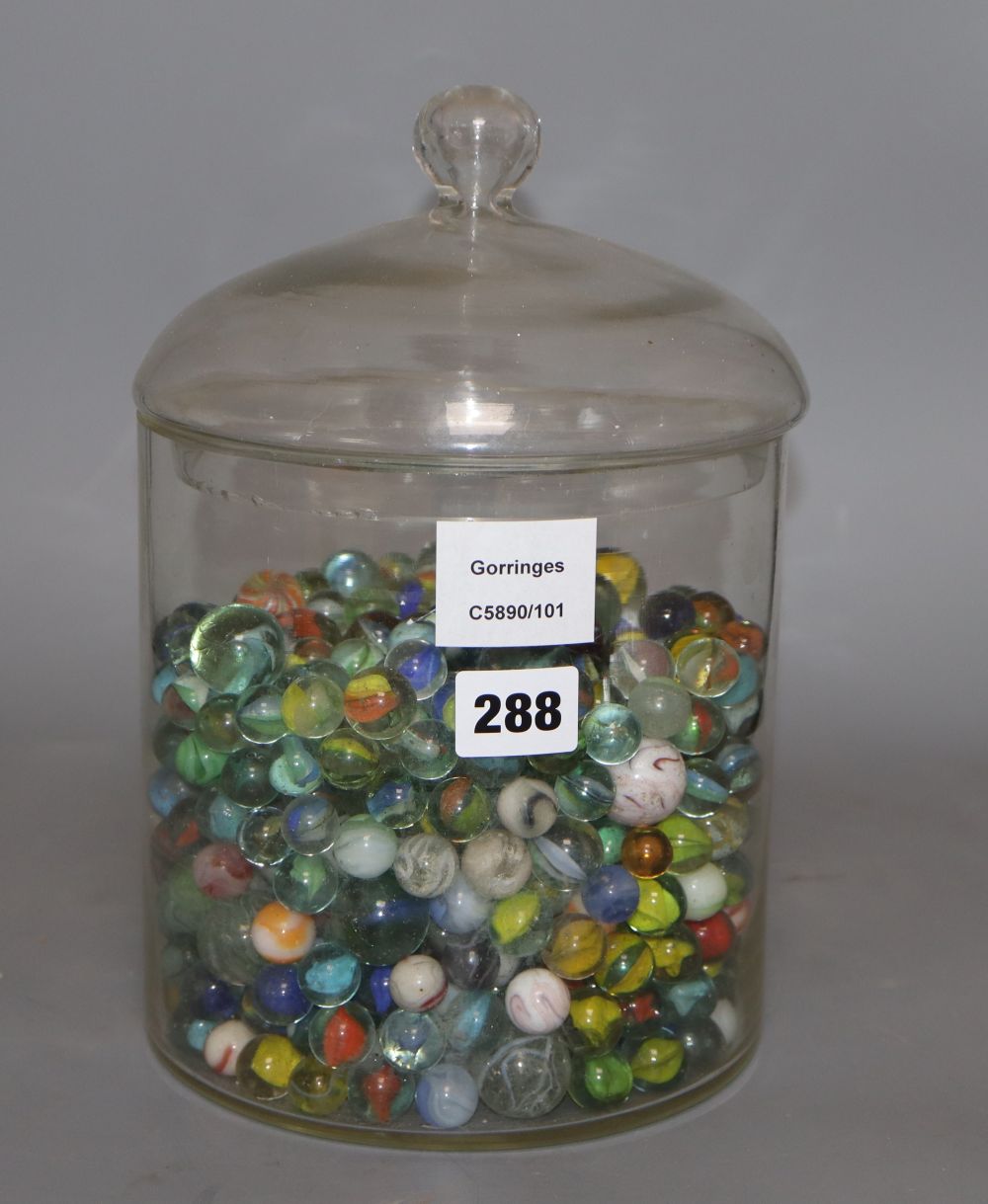 A glass jar and cover containing Victorian and later coloured marbles, height 26.5cm